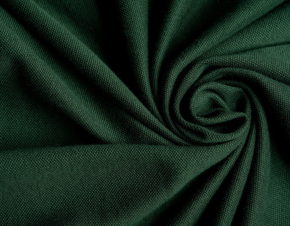 Dark green knitted fabric showing fine stitch texture and soft folds.